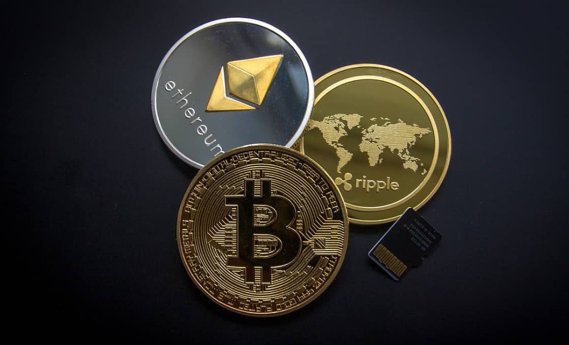 A collection of cryptocurrency coins including Bitcoin, Ethereum, and Ripple
