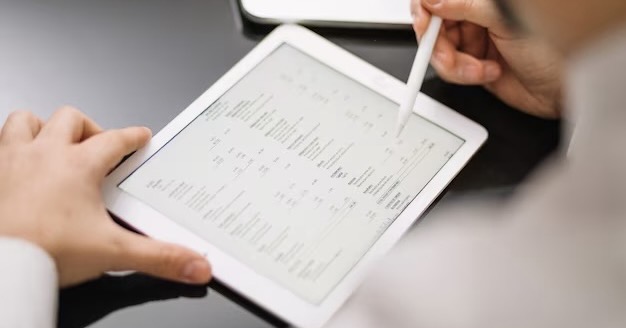 A man manages data on a tablet using a pen